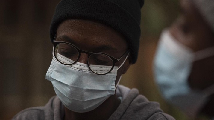 Virus Outbreak New Variant A student from the Tshwane University of Technology wears a face mask outside his residence in Pretoria, South Africa, Saturday, Nov. 27, 2021. As the world grapples with the emergence of the new variant of COVID-19, scientists in South Africa — where omicron was first identified — are scrambling to combat its spread across the country. (AP Photo/Denis Farrell)