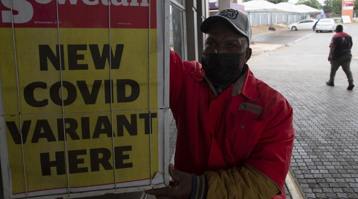 Virus Outbreak New Variant A petrol attendant stands next to a newspaper headline in Pretoria, South Africa, Saturday, Nov. 27, 2021. As the world grapples with the emergence of the new variant of COVID-19, scientists in South Africa — where omicron was first identified — are scrambling to combat its spread across the country. (AP Photo/Denis Farrell)