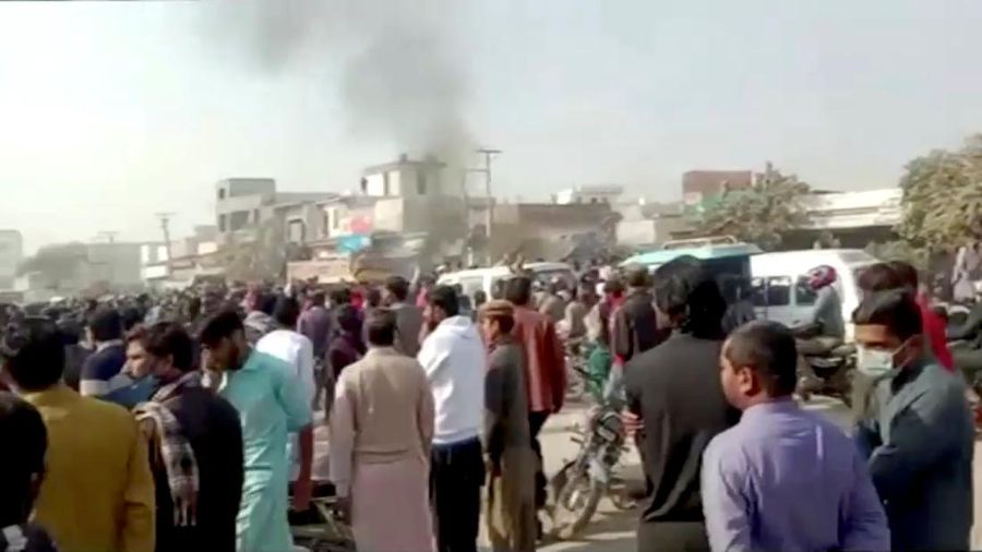 People gather after an attack on a factory in Sialkot, Pakistan December 3, 2021, in this screen grab taken from a video.   Reuters TV via REUTERS  THIS IMAGE HAS BEEN SUPPLIED BY A THIRD PARTY.