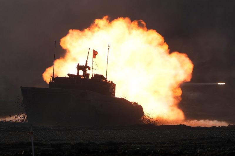 Japan Military Japanese Ground-Self Defense Force (JGDDF) Type 90 tanks drive toward a target during the annual drill with live ammunitions exercise at Minami Eniwa Camp Monday, Dec. 6, 2021, in Eniwa, northern Japan of Hokkaido. Dozens of tanks are rolling over the next two weeks on Hokkaido, a main military stronghold for a country with perhaps the world's most little known yet powerful army. (AP Photo/Eugene Hoshiko)