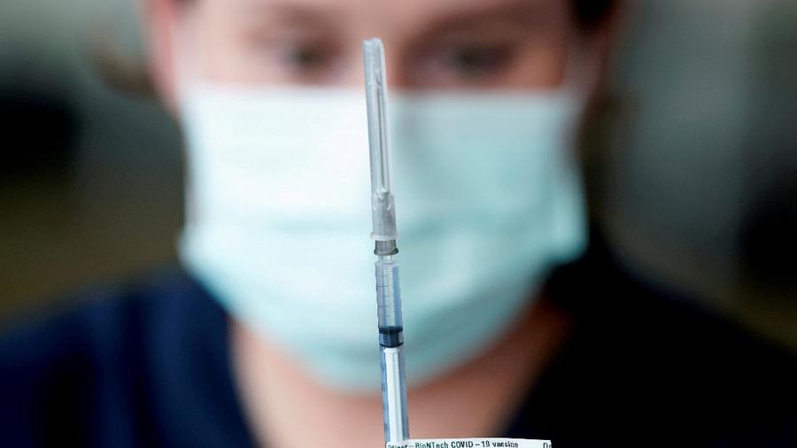FILE PHOTO: A healthcare professional prepares a dose of the Pfizer coronavirus disease (COVID-19) vaccine as high-risk workers receive the first vaccines in the state of Victoria's rollout of the program, in Melbourne, Australia, February 22, 2021. REUTERS/Sandra Sanders/File Photo
