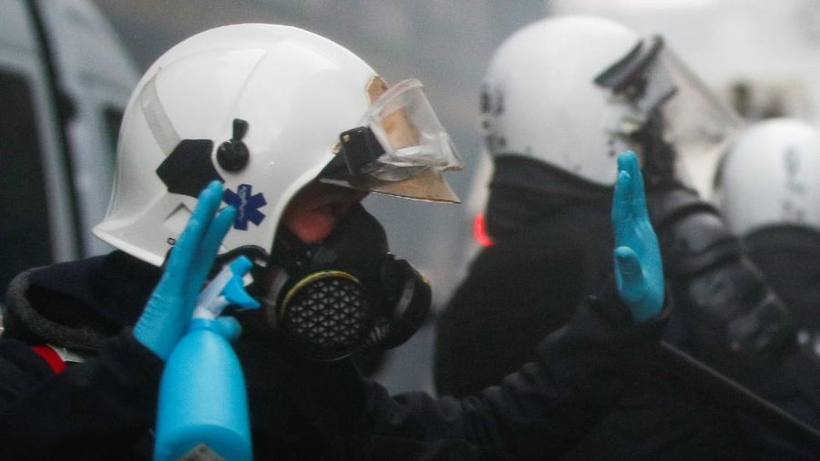 Burning objects are seen on the street during a protest against the Belgian government's restrictions imposed to contain the spread of the coronavirus disease (COVID-19), in Brussels, Belgium December 5, 2021. REUTERS/Johanna Geron