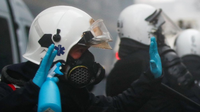 Burning objects are seen on the street during a protest against the Belgian government's restrictions imposed to contain the spread of the coronavirus disease (COVID-19), in Brussels, Belgium December 5, 2021. REUTERS/Johanna Geron