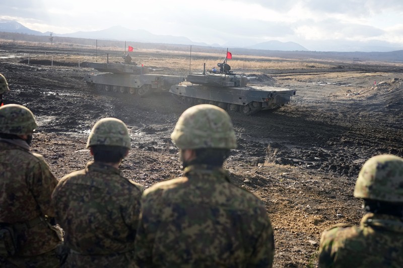 Japan Military Japanese Ground-Self Defense Force (JGDDF) Type 90 tanks drive toward a target during the annual drill with live ammunitions exercise at Minami Eniwa Camp Monday, Dec. 6, 2021, in Eniwa, northern Japan of Hokkaido. Dozens of tanks are rolling over the next two weeks on Hokkaido, a main military stronghold for a country with perhaps the world's most little known yet powerful army. (AP Photo/Eugene Hoshiko)