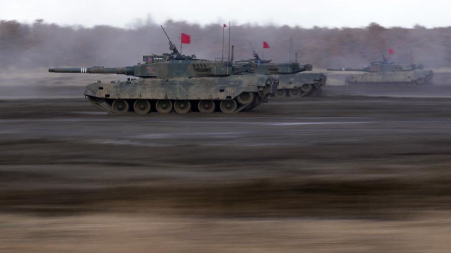 Japanese Ground-Self Defense Force (JGDDF) Type 90 tanks drive toward a target during the annual drill with live ammunitions exercise at Minami Eniwa Camp Monday, Dec. 6, 2021, in Eniwa, northern Japan of Hokkaido. Dozens of tanks are rolling over the next two weeks on Hokkaido, a main military stronghold for a country with perhaps the world's most little known yet powerful army. (AP Photo/Eugene Hoshiko)