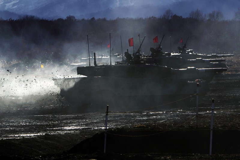 Japan Military Japanese Ground-Self Defense Force (JGDDF) Type 90 tanks drive toward a target during the annual drill with live ammunitions exercise at Minami Eniwa Camp Monday, Dec. 6, 2021, in Eniwa, northern Japan of Hokkaido. Dozens of tanks are rolling over the next two weeks on Hokkaido, a main military stronghold for a country with perhaps the world's most little known yet powerful army. (AP Photo/Eugene Hoshiko)
