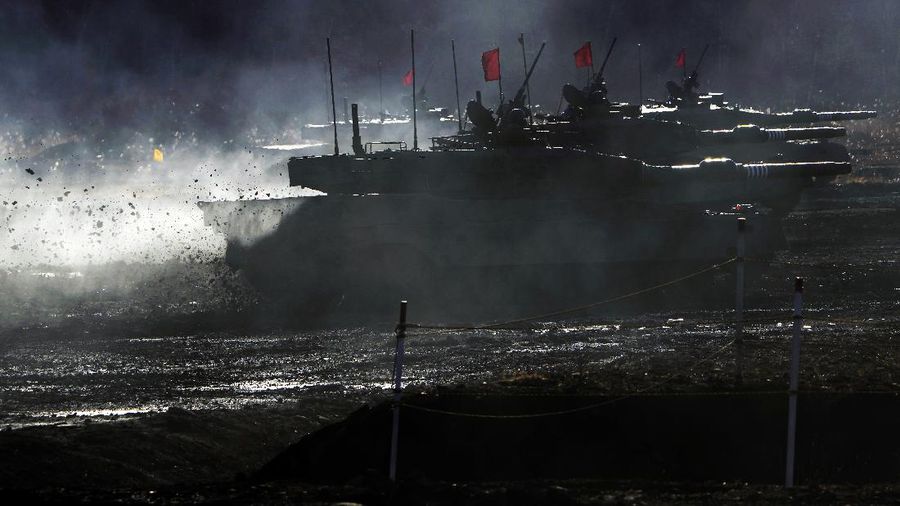 Japanese Ground-Self Defense Force (JGDDF) Type 90 tanks drive toward a target during the annual drill with live ammunitions exercise at Minami Eniwa Camp Monday, Dec. 6, 2021, in Eniwa, northern Japan of Hokkaido. Dozens of tanks are rolling over the next two weeks on Hokkaido, a main military stronghold for a country with perhaps the world's most little known yet powerful army. (AP Photo/Eugene Hoshiko)
