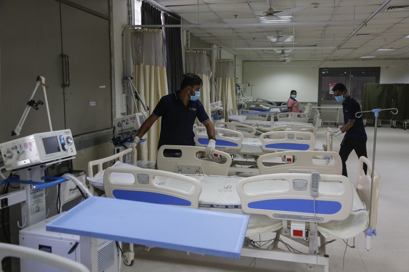 A health worker sets up beds inside a ward being prepared for the omicron coronavirus variant at Civil hospital in Ahmedabad, India, Monday, Dec. 6, 2021. (AP Photo/Ajit Solanki)