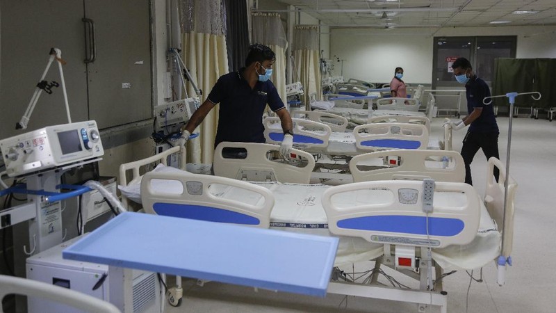A health worker sets up beds inside a ward being prepared for the omicron coronavirus variant at Civil hospital in Ahmedabad, India, Monday, Dec. 6, 2021. (AP Photo/Ajit Solanki)
