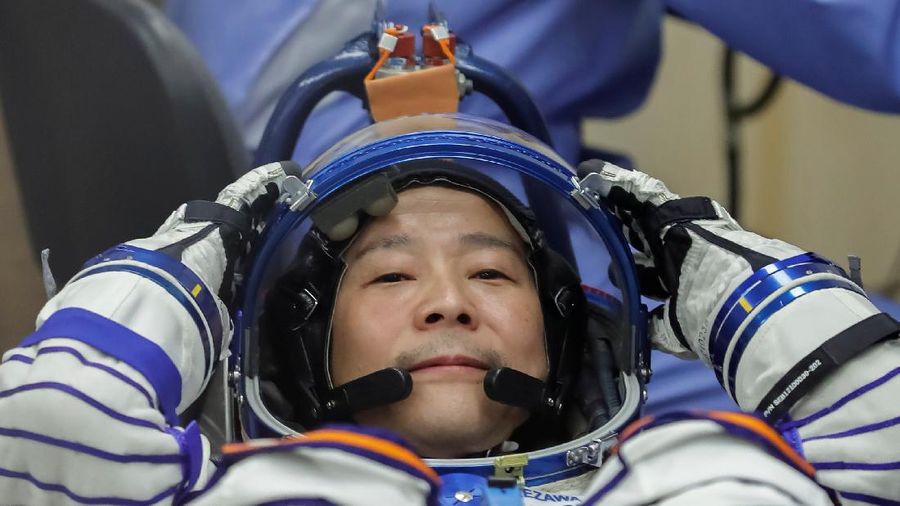 Japanese entrepreneur Yusaku Maezawa reacts as he speaks with his family after donning space suits shortly before the launch to the International Space Station (ISS) at the Baikonur Cosmodrome, Kazakhstan, December 8, 2021.  REUTERS/Shamil Zhumatov