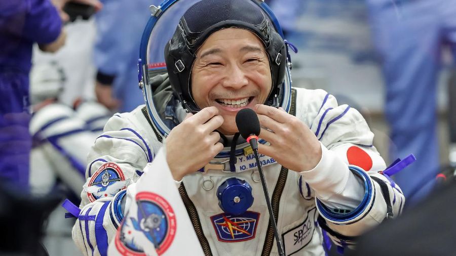 Japanese entrepreneur Yusaku Maezawa reacts as he speaks with his family after donning space suits shortly before the launch to the International Space Station (ISS) at the Baikonur Cosmodrome, Kazakhstan, December 8, 2021. REUTERS/Shamil Zhumatov