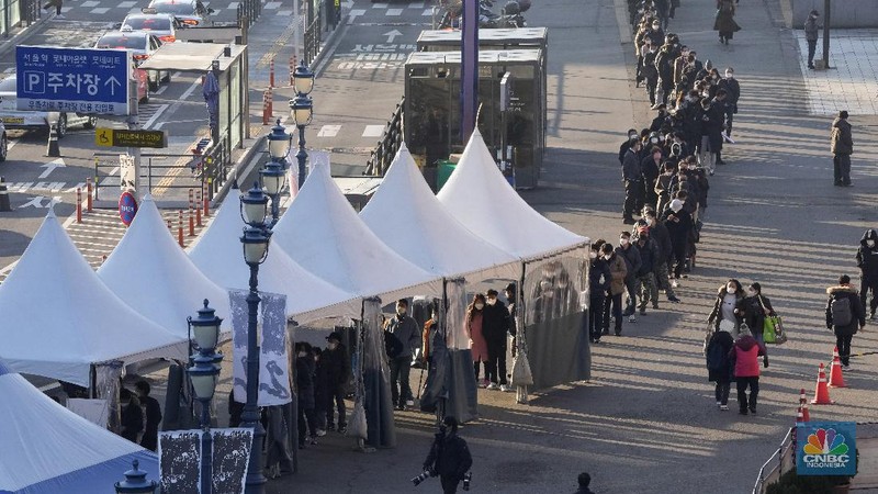 People queue in line to wait for the coronavirus testing at a makeshift testing site in Seoul, South Korea, Wednesday, Dec. 8, 2021. (AP Photo/Ahn Young-joon).