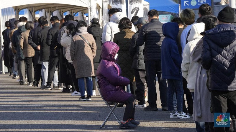 People queue in line to wait for the coronavirus testing at a makeshift testing site in Seoul, South Korea, Wednesday, Dec. 8, 2021. (AP Photo/Ahn Young-joon).