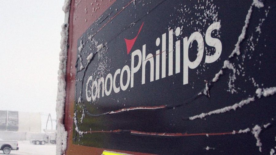 FILE - This Feb. 9, 2016, file photo shows an ice-covered ConocoPhillips sign at a drilling site in Nuiqsut, Alaska. ConocoPhillips is buying shale producer Concho Resources in an all-stock deal valued at $9.7 billion. The companies said Monday, Oct. 19, 2020, that the combined business will be the largest independent oil and gas company, with pro forma production of more than 1.5 million barrels of oil equivalent per day.  (AP Photo/Mark Thiessen, File)