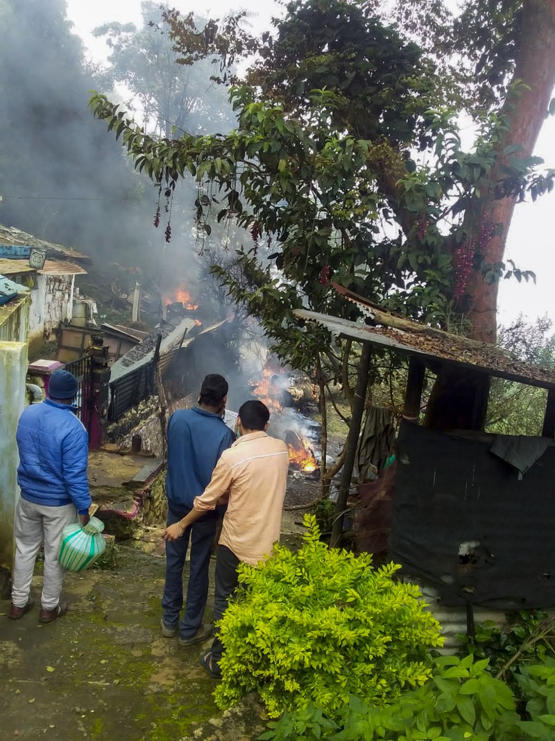 Smoke rises from fire after an army helicopter carrying India's Chief of Defense Staff Bipin Rawat crashed near Coonoor, Tamil Nadu state,  India, Wednesday, Dec. 8, 2021. India’s military chief, Gen. Bipin Rawat, and 12 others were killed Wednesday in a helicopter crash in southern Tamil Nadu state, the air force said. (Bangalore New Photos via AP)