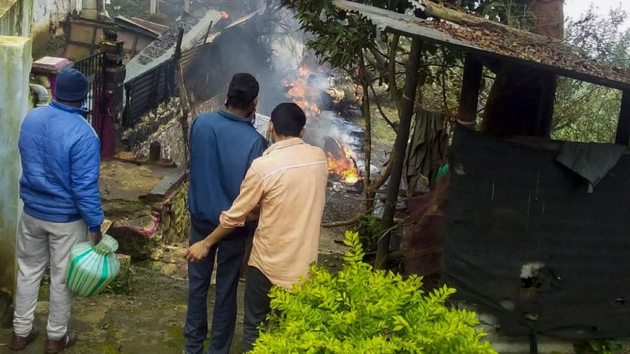 Smoke rises from fire after an army helicopter carrying India's Chief of Defense Staff Bipin Rawat crashed near Coonoor, Tamil Nadu state,  India, Wednesday, Dec. 8, 2021. India’s military chief, Gen. Bipin Rawat, and 12 others were killed Wednesday in a helicopter crash in southern Tamil Nadu state, the air force said. (Bangalore New Photos via AP)