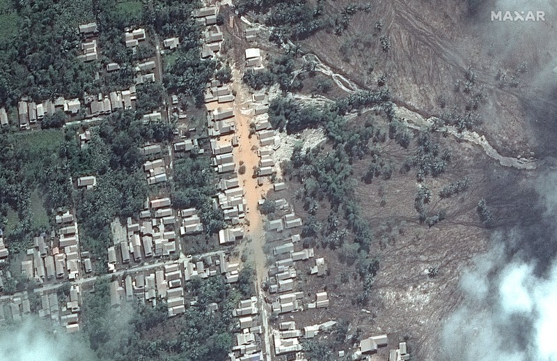 Indonesia Volcano A combination of two satellite images provided by Satellite image ©2021 Maxar Technologies from Nov. 15, 2019, left, and Dec. 8, 2021, shows the mud and ash flows that swept through the area of Roboan, East Java, Indonesia from the eruption of nearby volcano Mount Semeru. The volcano erupted on Saturday, killing at dozens of people with searing ash and gas that blanketed several villages around it. (Maxar Technologies via AP)