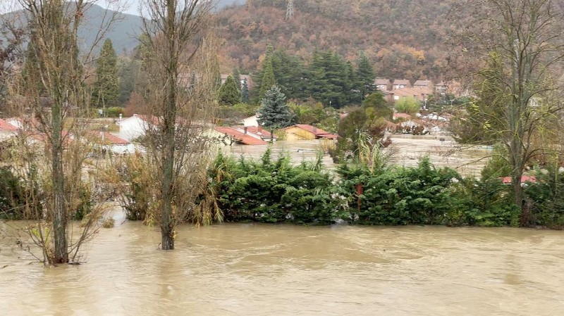 A man rides a kayak on a flooded road, following heavy rainfall in Pamplona, Spain, December 10, 2021. REUTERS/Vincent West