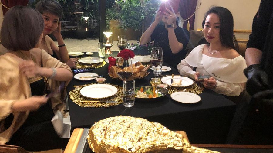 A chef serves a gold leaf-coated steak to a Vietnam War veteran, tapping in on a wave of publicity after a government minister was caught on camera being fed the dish at a London restaurant, at a Dolce By Wyndham Hanoi Golden Lake hotel, in Hanoi, Vietnam December 4, 2021. Picture taken December 4, 2021. REUTERS/Minh Nguyen