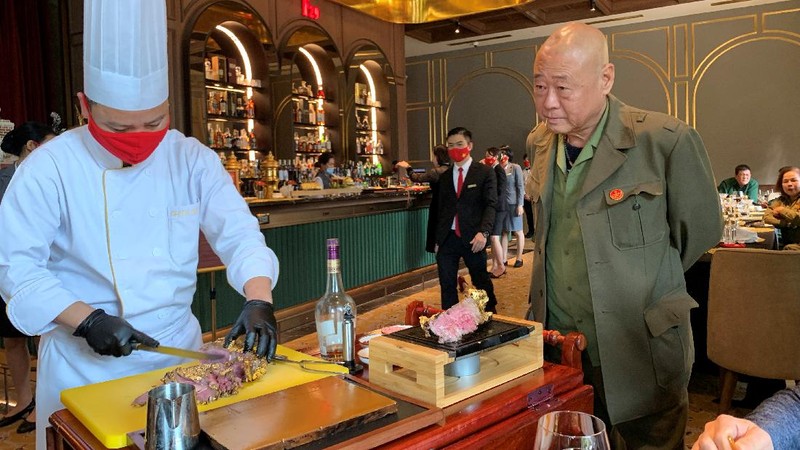 A chef serves a gold leaf-coated steak to a Vietnam War veteran, tapping in on a wave of publicity after a government minister was caught on camera being fed the dish at a London restaurant, at a Dolce By Wyndham Hanoi Golden Lake hotel, in Hanoi, Vietnam December 4, 2021. Picture taken December 4, 2021. REUTERS/Minh Nguyen