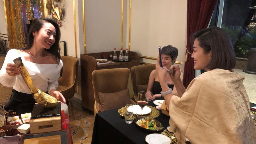 A chef serves a gold leaf-coated steak to a Vietnam War veteran, tapping in on a wave of publicity after a government minister was caught on camera being fed the dish at a London restaurant, at a Dolce By Wyndham Hanoi Golden Lake hotel, in Hanoi, Vietnam December 4, 2021. Picture taken December 4, 2021. REUTERS/Minh Nguyen