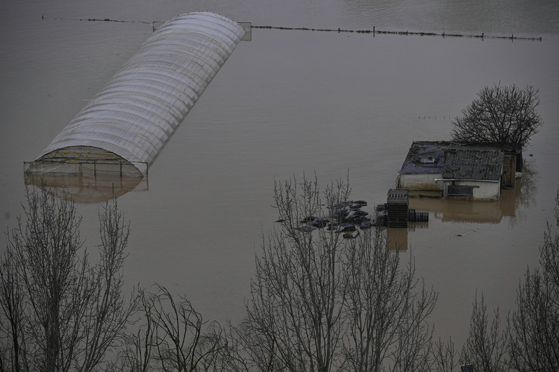 SPAIN-WEATHER/ A man rides a kayak on a flooded road, following heavy rainfall in Pamplona, Spain, December 10, 2021. REUTERS/Vincent West