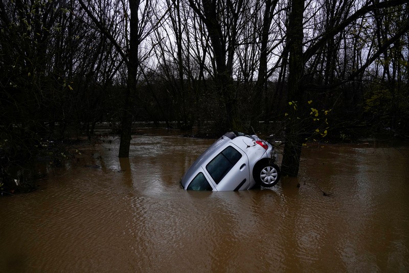 A man rides a kayak on a flooded road, following heavy rainfall in Pamplona, Spain, December 10, 2021. REUTERS/Vincent West
