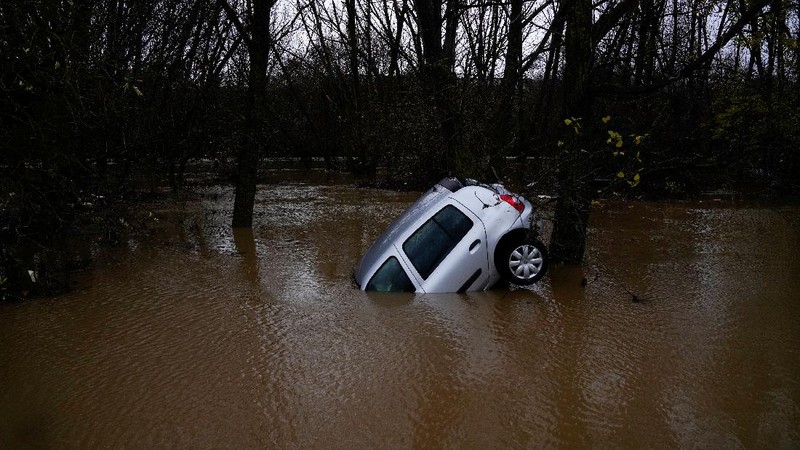 A man rides a kayak on a flooded road, following heavy rainfall in Pamplona, Spain, December 10, 2021. REUTERS/Vincent West