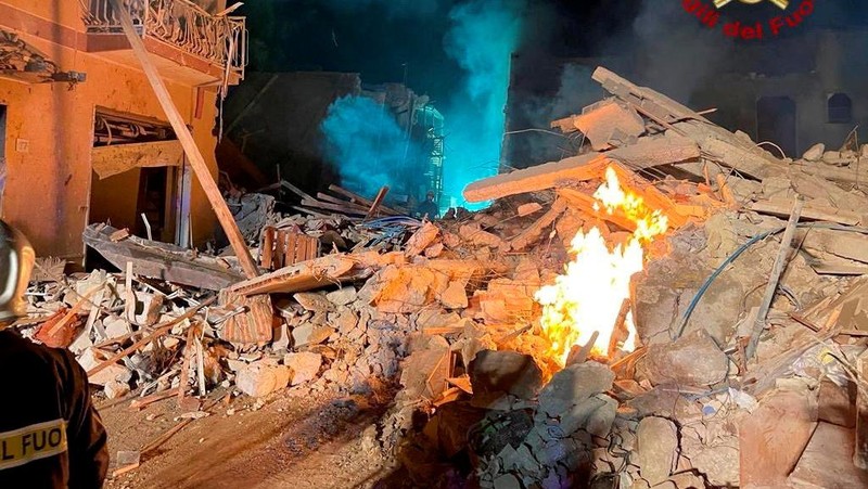 Debris is seen as members of the fire brigade work to rescue survivors after a four-storey building collapsed in the Sicilian town of Ravanusa following a gas explosion, in Italy, in this undated image obtained via social media on December 12, 2021.  Vigili del Fuoco via REUTERS ATTENTION EDITORS - THIS IMAGE HAS BEEN SUPPLIED BY A THIRD PARTY. WATERMARK FROM SOURCE. DO NOT OBSCURE LOGO.