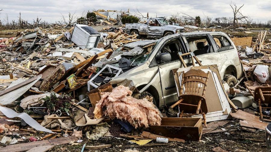 Damaged vehicles and personal property are strewn over a wide area along Kentucky 81, Saturday, Dec. 11, 2021, in Bremen, Ky, after a devastating tornado swept through the area on Friday night. (Greg Eans/The Messenger-Inquirer via AP)