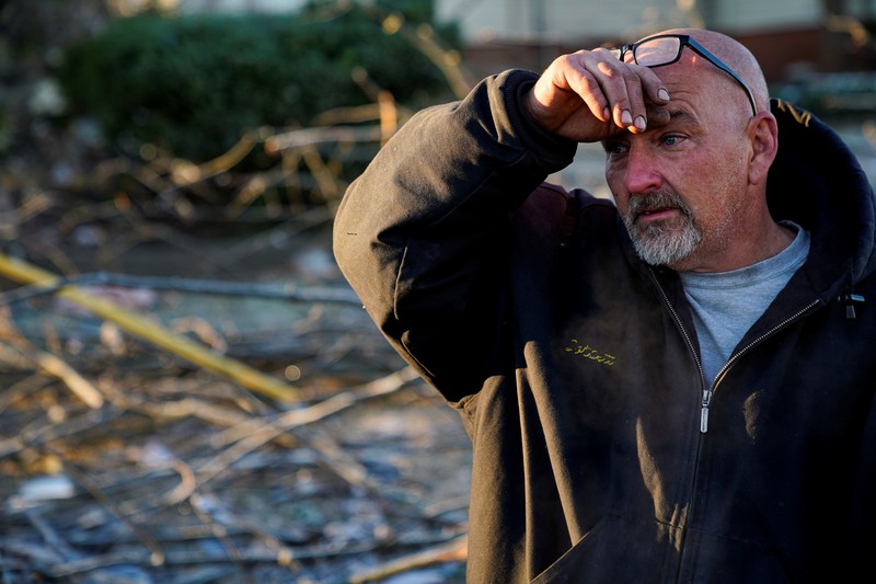 USA-WEATHER/TORNADOES Local residents Darlene Easterwood and Tim Evans embrace after taking part in an outdoor Sunday service with members of First Christian Church and First Presbyterian Church in the aftermath of a tornado in Mayfield, Kentucky, U.S. December 12, 2021. Both churches were left extensively damaged. REUTERS/Adrees Latif