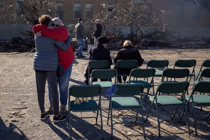 USA-WEATHER/TORNADOES Local residents Darlene Easterwood and Tim Evans embrace after taking part in an outdoor Sunday service with members of First Christian Church and First Presbyterian Church in the aftermath of a tornado in Mayfield, Kentucky, U.S. December 12, 2021. Both churches were left extensively damaged. REUTERS/Adrees Latif