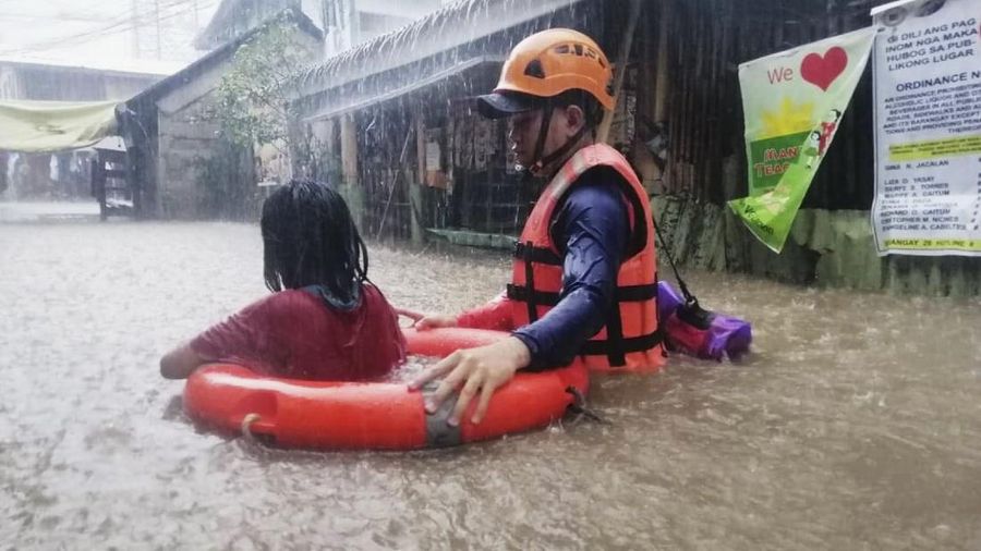 Tim penyelamat membantu warga saat banjir yang disebabkan oleh Topan Rai saat mereka dievakuasi ke tempat yang lebih tinggi di Kota Cagayan de Oro, Filipina selatan, Kamis (16/12/2021). Puluhan ribu orang terdampar dievakuasi ke tempat yang aman di Filipina selatan dan tengah ketika Topan Rai mendekati Kamis pada saat pihak berwenang memperingatkan masyarakat untuk menghindari kerumunan setelah infeksi pertama yang disebabkan oleh jenis virus corona dilaporkan di negara itu, kata para pejabat. (Philippine Coast Guard via AP)