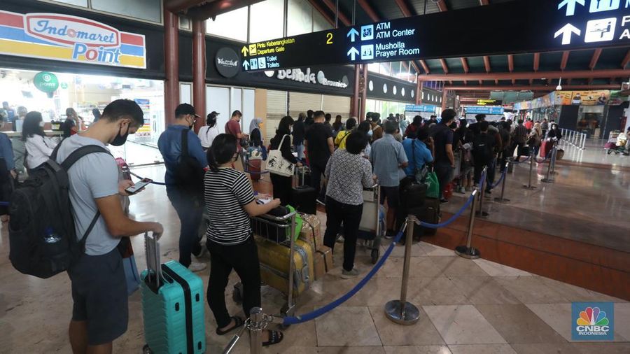 Puluhan penumpang mengantre di loket validasi syarat berkas kesehatan penumpang di Terminal 2 Keberangkatan Domestik, Bandara Soekarno-Hatta, Tangerang, Jumat (24/12/2021). (CNBC Indonesia/Andrean Kristianto)