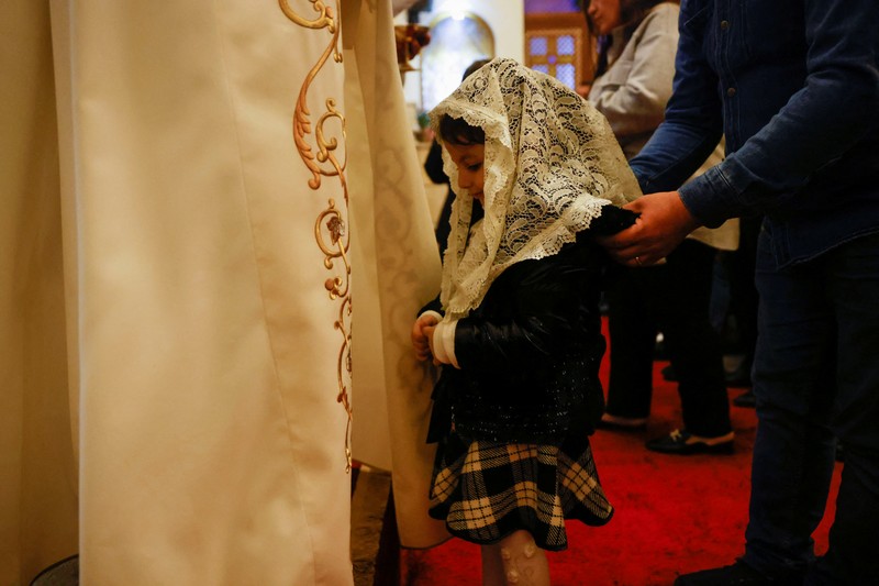 Pope Francis kisses a statue of baby Jesus as he celebrates Christmas Eve Holy Mass in St. Peter's Basilica at the Vatican, December 24, 2021. REUTERS/Guglielmo Mangiapane     TPX IMAGES OF THE DAY