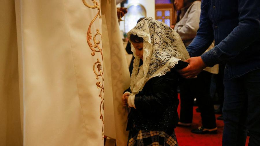 Pope Francis kisses a statue of baby Jesus as he celebrates Christmas Eve Holy Mass in St. Peter's Basilica at the Vatican, December 24, 2021. REUTERS/Guglielmo Mangiapane     TPX IMAGES OF THE DAY