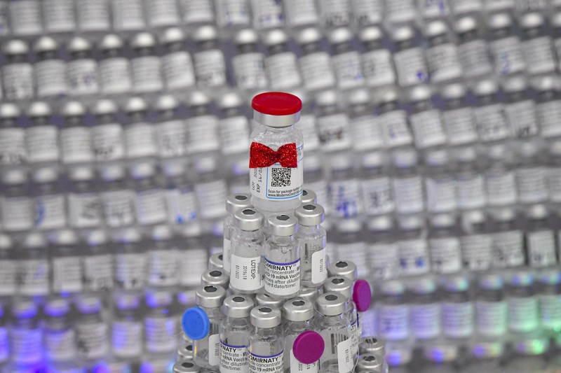 LEDs shine inside a Christmas tree made of empty vaccine containers at a vaccination center in Bucharest, Romania, Monday, Dec. 6, 2021. Staff at one of the largest COVID-19 vaccination centers in Bucharest, Romania, have built a three meter tall Christmas tree out of 19 thousand empty vaccine COVID-19 containers, some with colored LEDs placed inside them, they collected since March 2021 for the project. (AP Photo/Andreea Alexandru)