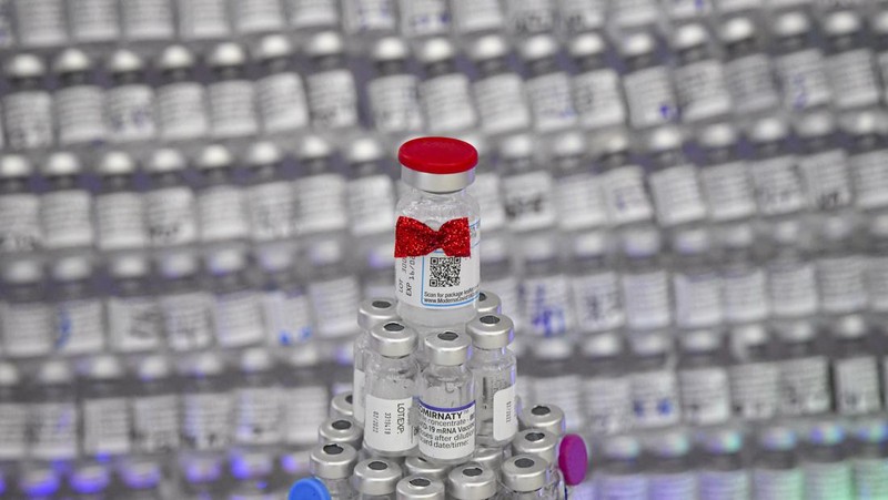 LEDs shine inside a Christmas tree made of empty vaccine containers at a vaccination center in Bucharest, Romania, Monday, Dec. 6, 2021. Staff at one of the largest COVID-19 vaccination centers in Bucharest, Romania, have built a three meter tall Christmas tree out of 19 thousand empty vaccine COVID-19 containers, some with colored LEDs placed inside them, they collected since March 2021 for the project. (AP Photo/Andreea Alexandru)