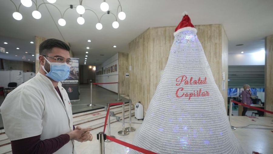 LEDs shine inside a Christmas tree made of empty vaccine containers at a vaccination center in Bucharest, Romania, Monday, Dec. 6, 2021. Staff at one of the largest COVID-19 vaccination centers in Bucharest, Romania, have built a three meter tall Christmas tree out of 19 thousand empty vaccine COVID-19 containers, some with colored LEDs placed inside them, they collected since March 2021 for the project. (AP Photo/Andreea Alexandru)