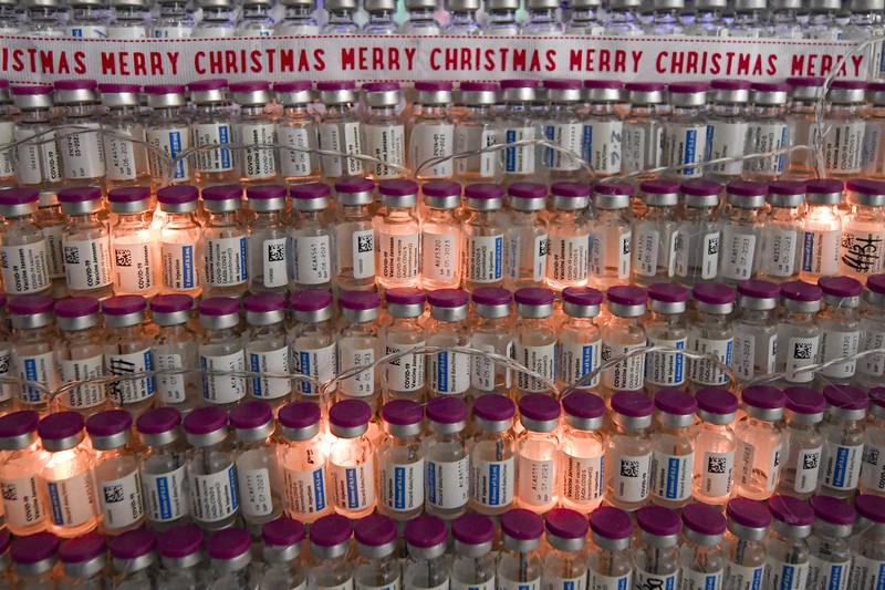 LEDs shine inside a Christmas tree made of empty vaccine containers at a vaccination center in Bucharest, Romania, Monday, Dec. 6, 2021. Staff at one of the largest COVID-19 vaccination centers in Bucharest, Romania, have built a three meter tall Christmas tree out of 19 thousand empty vaccine COVID-19 containers, some with colored LEDs placed inside them, they collected since March 2021 for the project. (AP Photo/Andreea Alexandru)