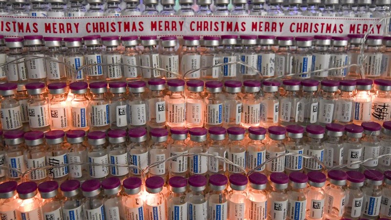 LEDs shine inside a Christmas tree made of empty vaccine containers at a vaccination center in Bucharest, Romania, Monday, Dec. 6, 2021. Staff at one of the largest COVID-19 vaccination centers in Bucharest, Romania, have built a three meter tall Christmas tree out of 19 thousand empty vaccine COVID-19 containers, some with colored LEDs placed inside them, they collected since March 2021 for the project. (AP Photo/Andreea Alexandru)