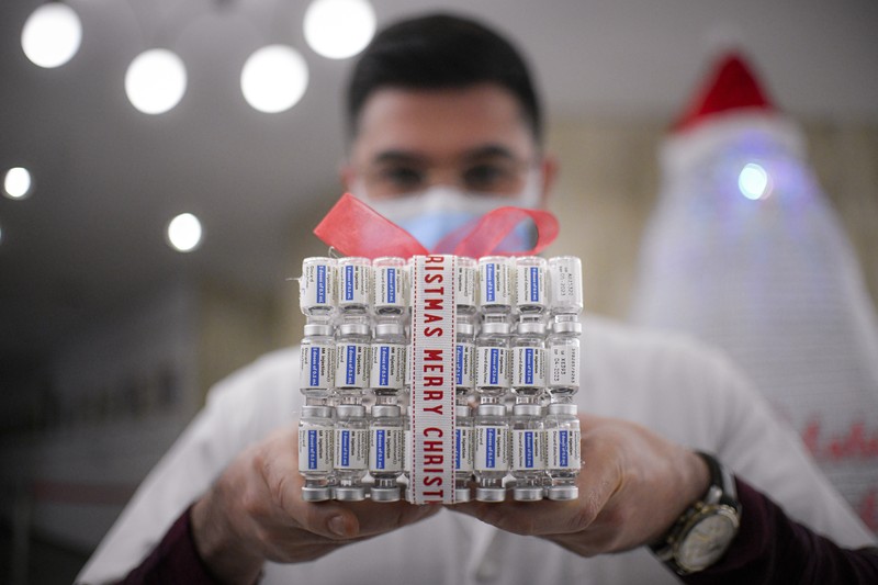 LEDs shine inside a Christmas tree made of empty vaccine containers at a vaccination center in Bucharest, Romania, Monday, Dec. 6, 2021. Staff at one of the largest COVID-19 vaccination centers in Bucharest, Romania, have built a three meter tall Christmas tree out of 19 thousand empty vaccine COVID-19 containers, some with colored LEDs placed inside them, they collected since March 2021 for the project. (AP Photo/Andreea Alexandru)