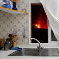 Lava is seen through the window of a kitchen following the eruption of a volcano in El Paso, La Palma, Spain, September 28, 2021. Reuters photographer Jon Nazca.