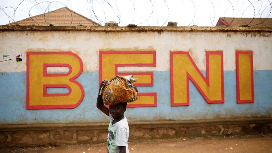 FILE PHOTO: A Congolese boy walks past a wall near the Alima Ebola treatment centre in Beni, in the Democratic Republic of Congo, April 1, 2019. Picture taken April 1, 2019.REUTERS/Baz Ratner/File Photo