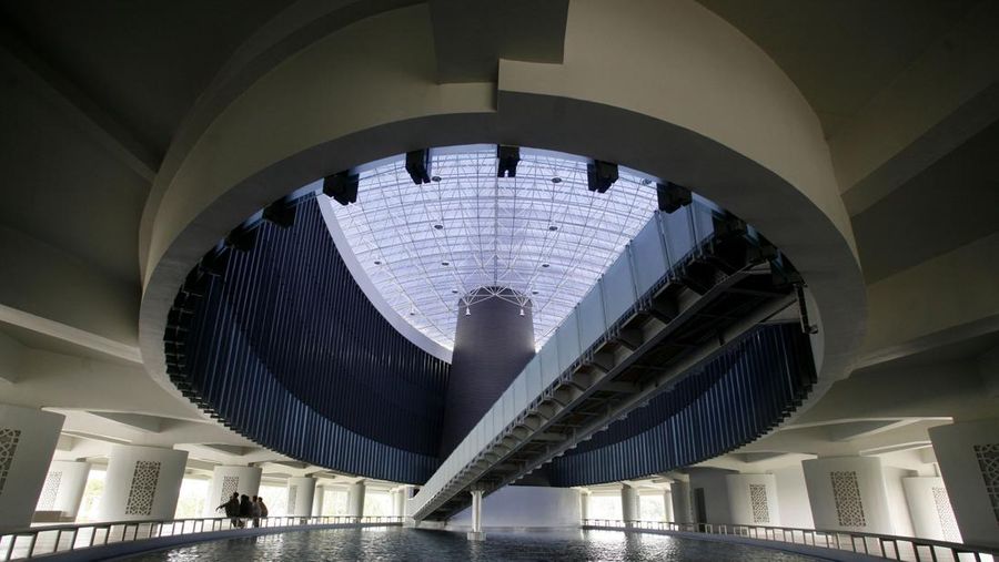 Acehnese sit down side by side inside the tsunami memorial and museum built to commemorate the 2004 Asian Tsunami that killed more than 200,000 people, in Banda Aceh, Indonesia, Monday, Feb. 2, 2009. (AP Photo/Binsar Bakkara)