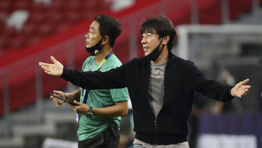 Indonesia head coach, Shin Tae Yong reacts at the touchline during the AFF Suzuki Cup 2020 semi-final second leg match between Indonesia and Singapore in Singapore, Sunday, Dec. 26, 2021. (AP Photo/Suhaimi Abdullah)