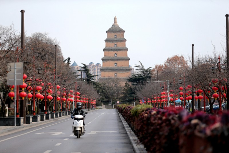 A rider travels on an empty road following lockdown measures to curb the spread of the coronavirus disease (COVID-19) in Xian, Shaanxi province, China December 26, 2021. Picture taken December 26, 2021. cnsphoto via REUTERS   ATTENTION EDITORS - THIS IMAGE WAS PROVIDED BY A THIRD PARTY. CHINA OUT.