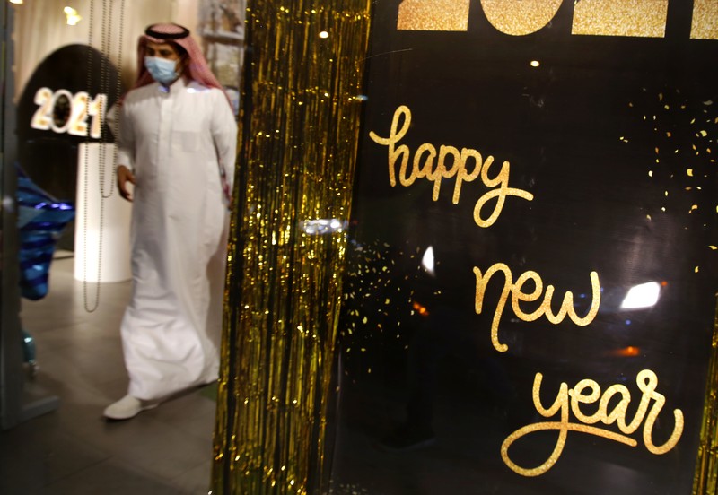 Virus Outbreak Saudi Christmas A woman wearing a mask to protect from the coronavirus leaves a gift shop decorated for Christmas and New Year in Jiddah, Saudi Arabia, Friday, Dec. 25, 2020. (AP Photo/Amr Nabil)