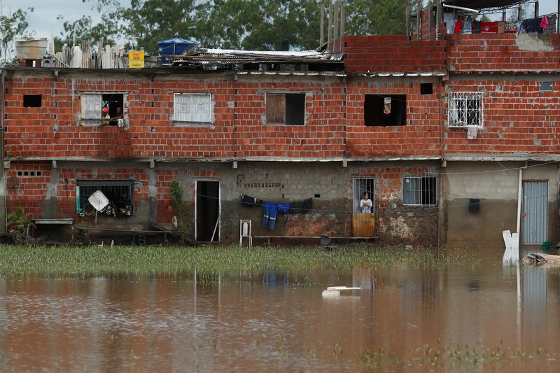 People take refuge in their houses, during floods caused by heavy rains in Itabuna, Bahia state, Brazil December 27, 2021. REUTERS/Amanda Perobelli