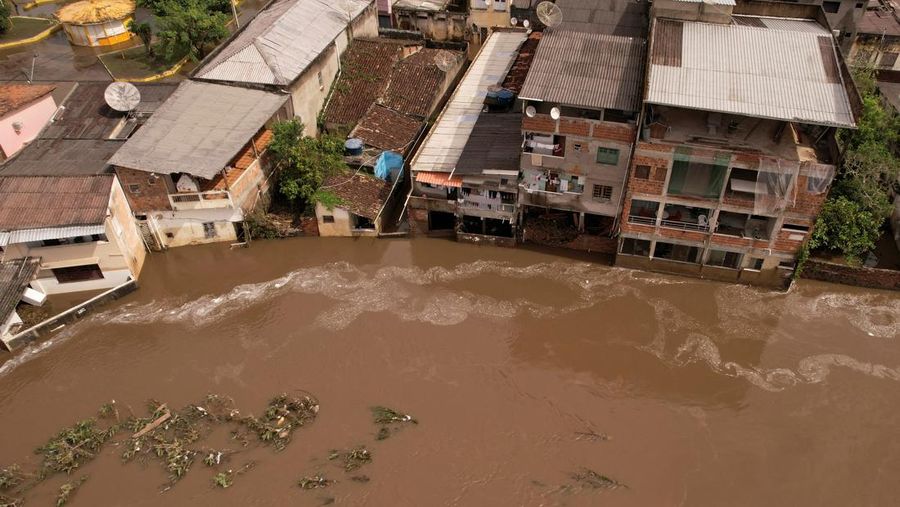 People take refuge in their houses, during floods caused by heavy rains in Itabuna, Bahia state, Brazil December 27, 2021. REUTERS/Amanda Perobelli
